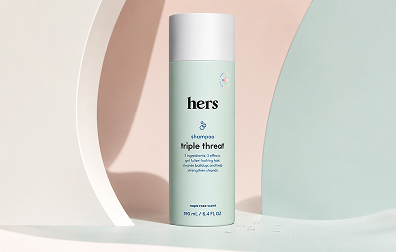 hers Triple Threat Shampoo with biotin, saw palmetto, and pumpkin seed oil on a clean pastel product background